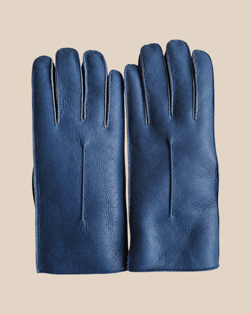 Nappa shearling gloves - blue — product view 01, shearling gloves on a beige background