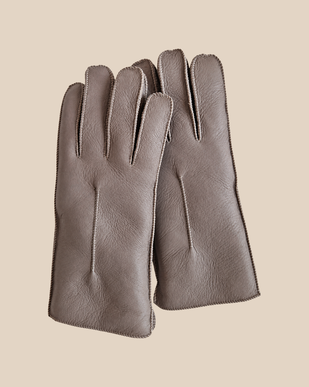 Nappa shearling gloves - snow grey — product view 01, shearling gloves on a beige background