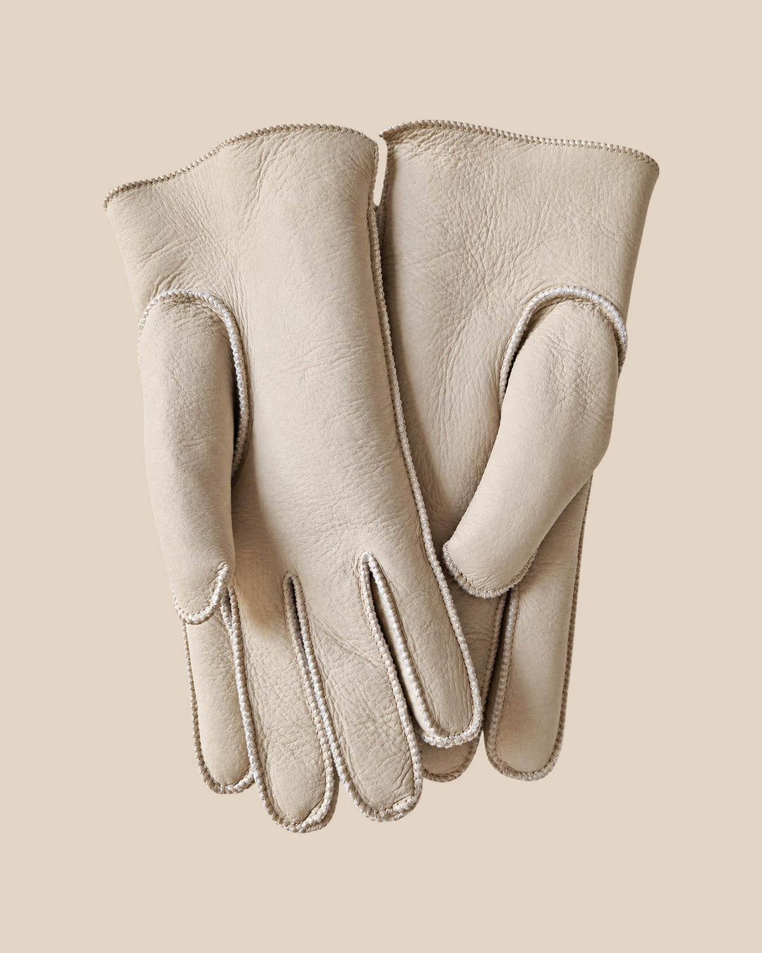 Nappa shearling gloves - white — product view 01, shearling gloves on a beige background