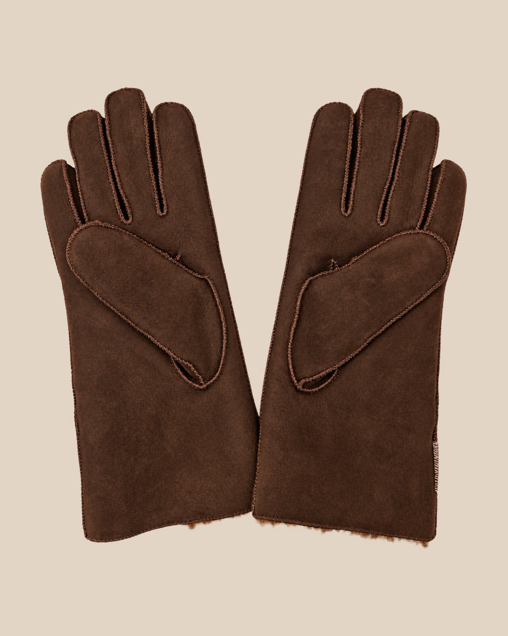 Suede shearling gloves - dark brown gilas — product view 02, shearling gloves on a beige background