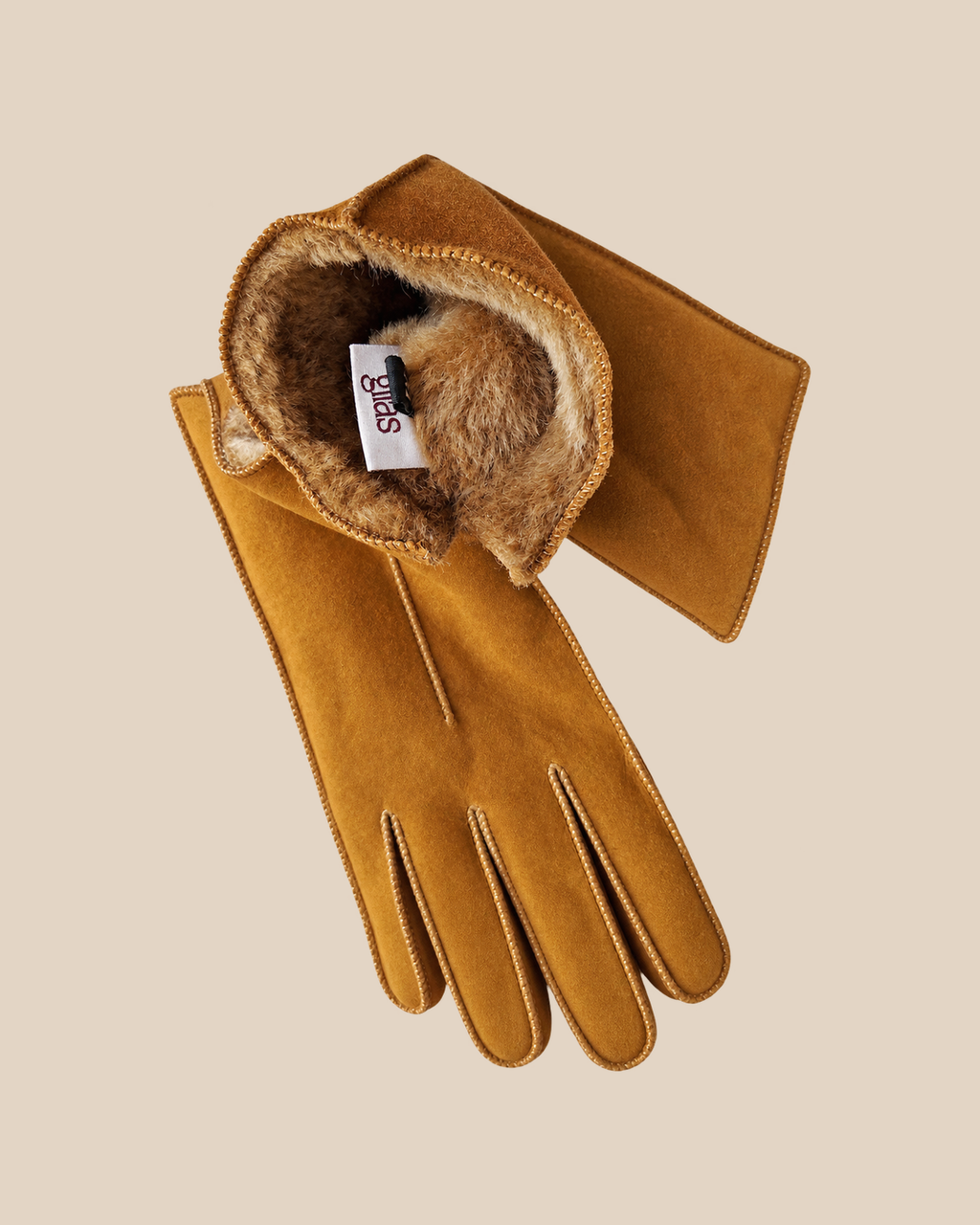Suede shearling gloves - whiskey — product view 05, shearling gloves on a beige background